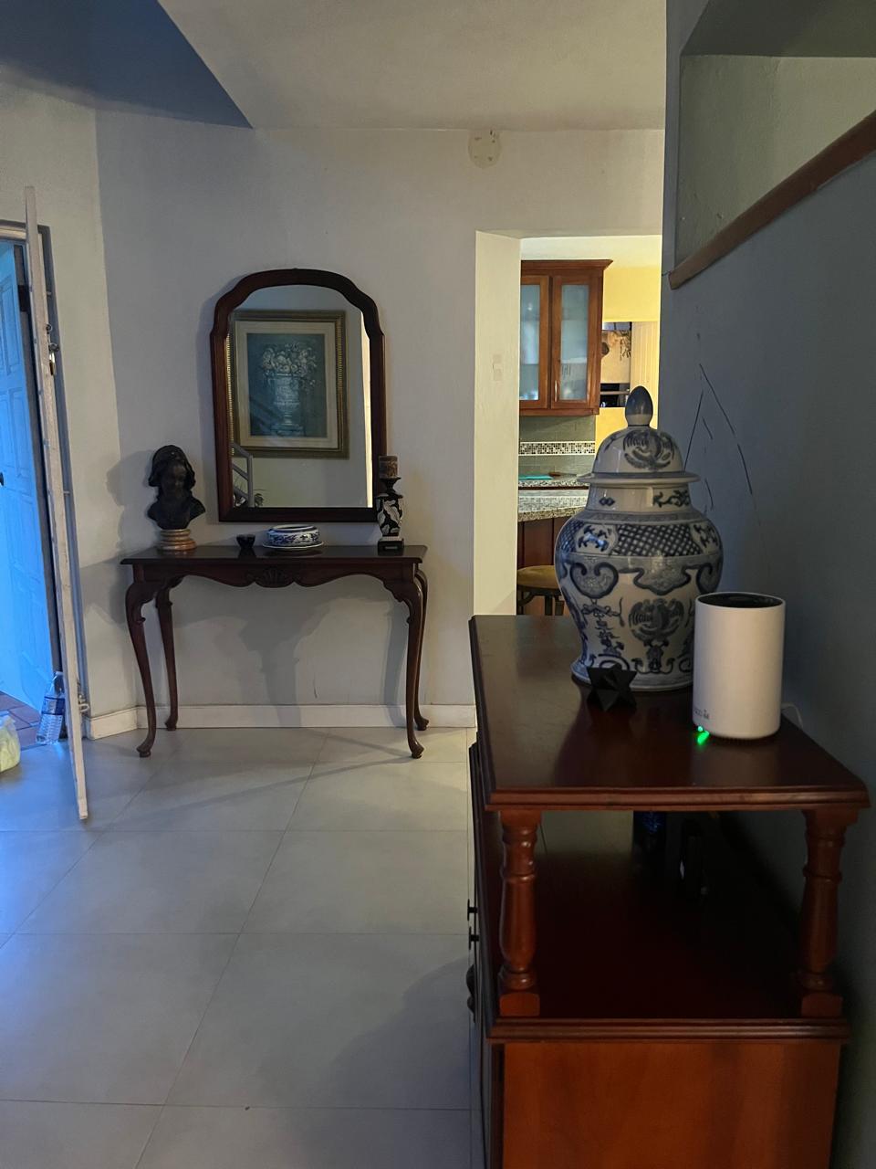 The same entryway fully cleared and styled with a clean floor and tidy console after Luxe Clean JA